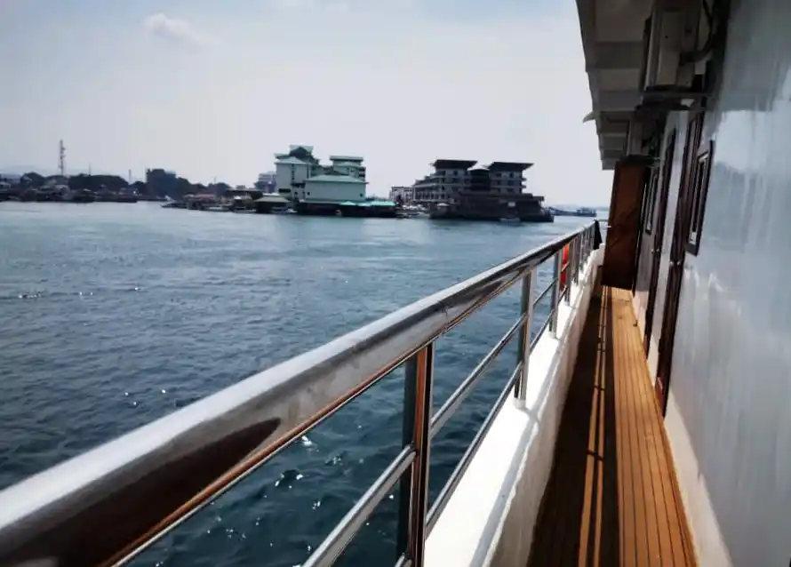 View from the deck of the MV Celebes Explorer 9 liveaboard, looking across the sea towards the seafront hotels of Semporna town.