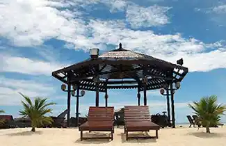 Relaxing lounge chairs on the man-made beach and sundeck at Kapalai Resort, a perfect spot to sunbathe under the gazebo.