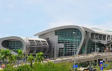 Sweeping glass facade of the Kota Kinabalu International Airport (KKIA), the primary arrival and departure hub for flights to Sabah, Borneo.