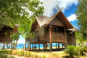 Exquisite King Chalet at Mataking Island Resort, featuring traditional architecture and a prime beachfront location with stunning sea views.