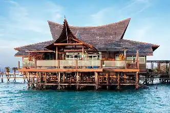 Grand and exclusive Royale Villa chalet at Mabul Water Bungalows, showcasing magnificent traditional architecture and standing majestically over the sea.