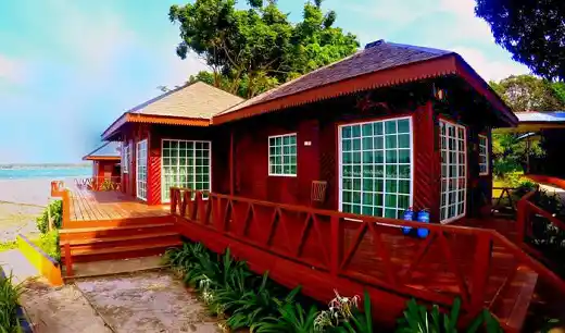 Enjoy your large deck at this budget-friendly resort. Beautiful red wooden chalet with a large deck at the Scuba Tiger Semporna Holiday Resort, offering budget-friendly accommodation.