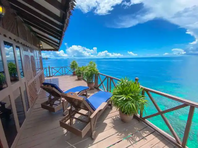 Panoramic sea view from a Deluxe Water Chalet balcony at Sipadan Water Village, ideal for divers or snorkelers to unwind between dives.