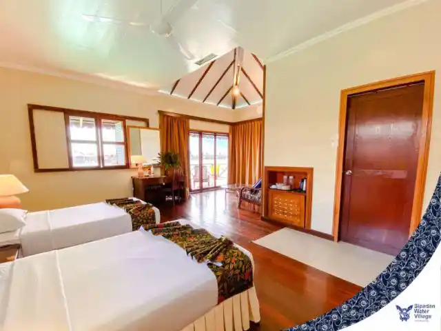 Cozy Standard Cottage at Sipadan Water Village features twin beds and sea-view windows that welcome tired divers after wall and macro dives.