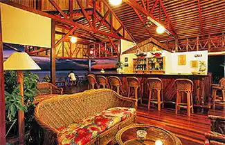 Relaxing bar and lounge area at Sipadan Water Village, with wicker furniture perfect for enjoying a sunset drink after a day of diving.