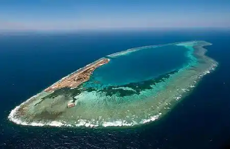 Spectacular aerial view of Layang Layang, a remote coral atoll in the South China Sea, famous for its deep walls and hammerhead shark diving.