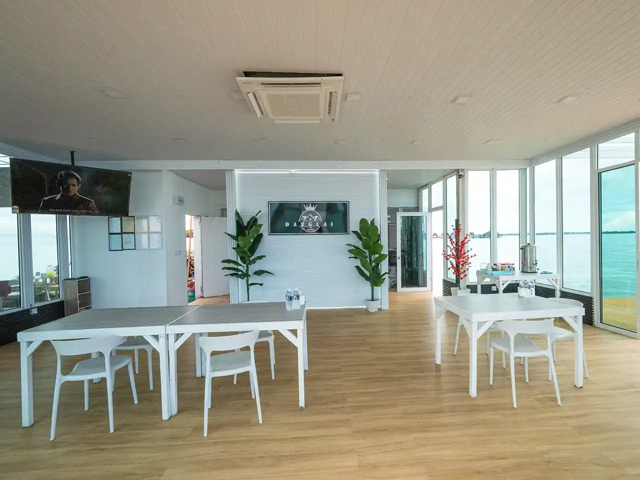 Bright and modern interior of the restaurant at Danglai Resort Semporna, offering panoramic sea views for guests while they dine.