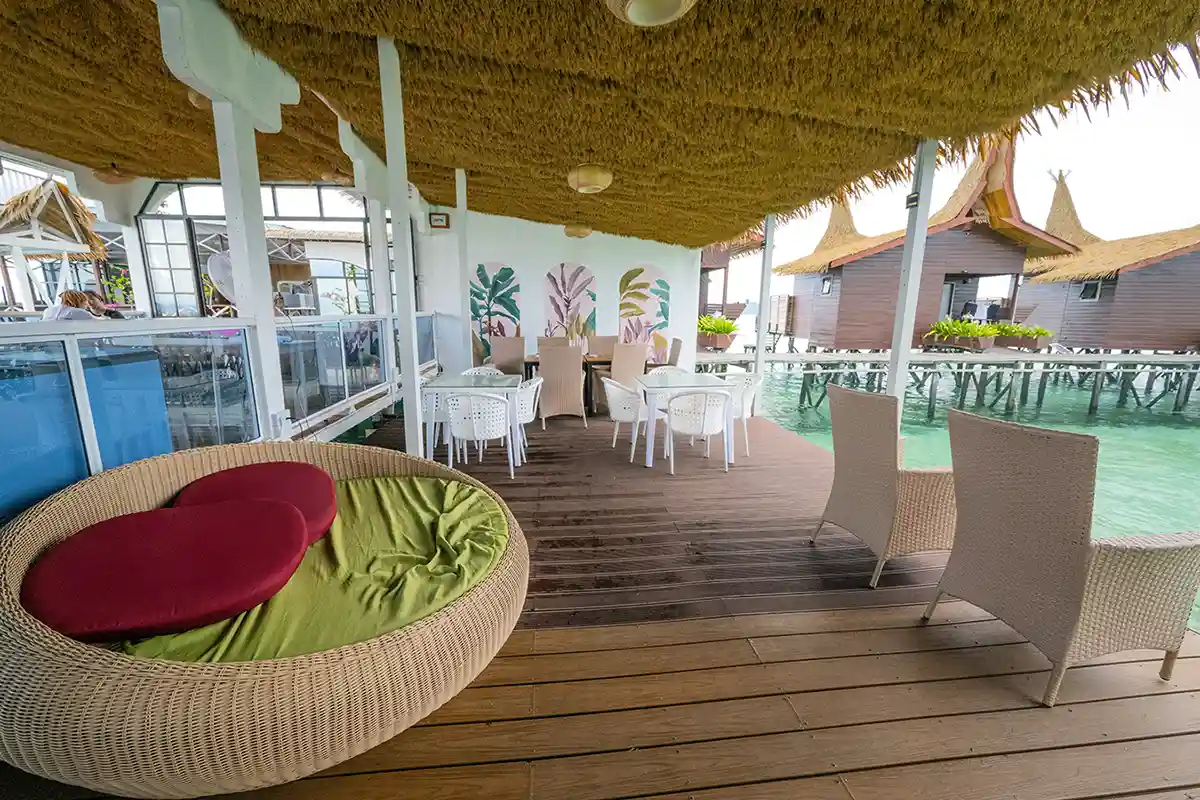 Relaxing open-air lounge and restaurant deck at Dayang Resort, with comfortable seating for enjoying meals and drinks right over the water.