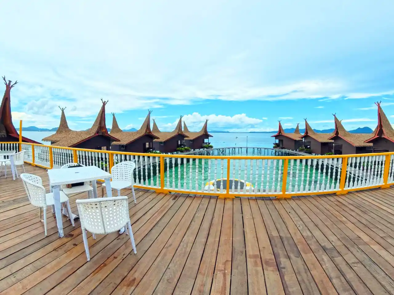 Main viewing terrace at Dayang Resort, with tables and chairs set up for guests to enjoy the panoramic view of the overwater hideaway.