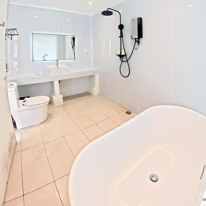 Sleek and modern bathroom at Royal Resort Semporna, with a luxurious freestanding bathtub and a separate walk-in shower.
