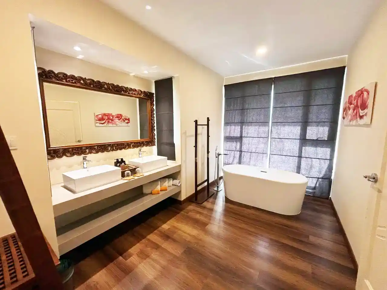 Spacious and luxurious bathroom at Sea Star Resort, featuring a modern freestanding bathtub, a double vanity, and an elegant ornate mirror.