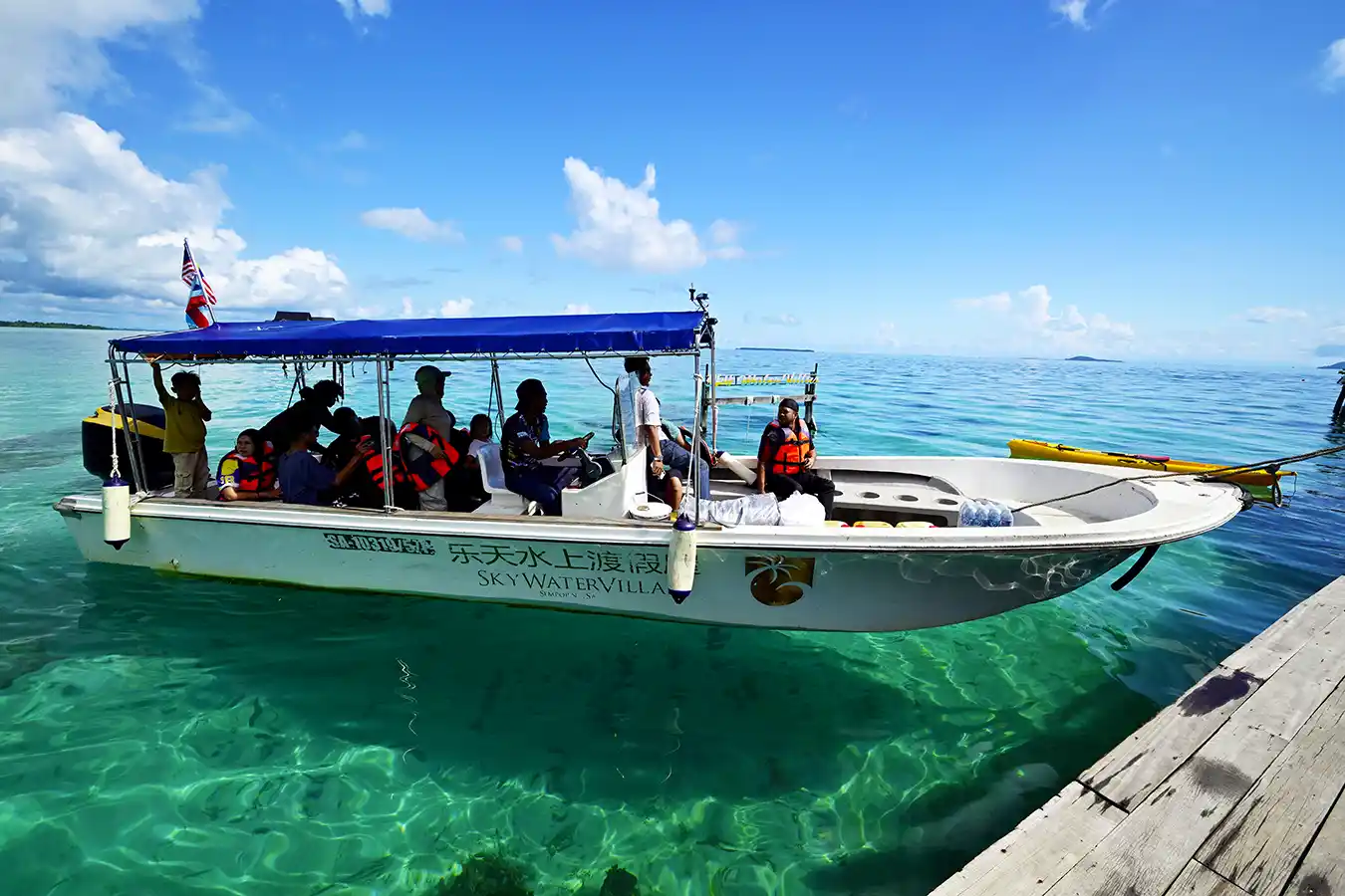 Guests aboard the Sky Water Villas speedboat, ready to depart for an exciting day of island hopping in the beautiful Semporna archipelago.